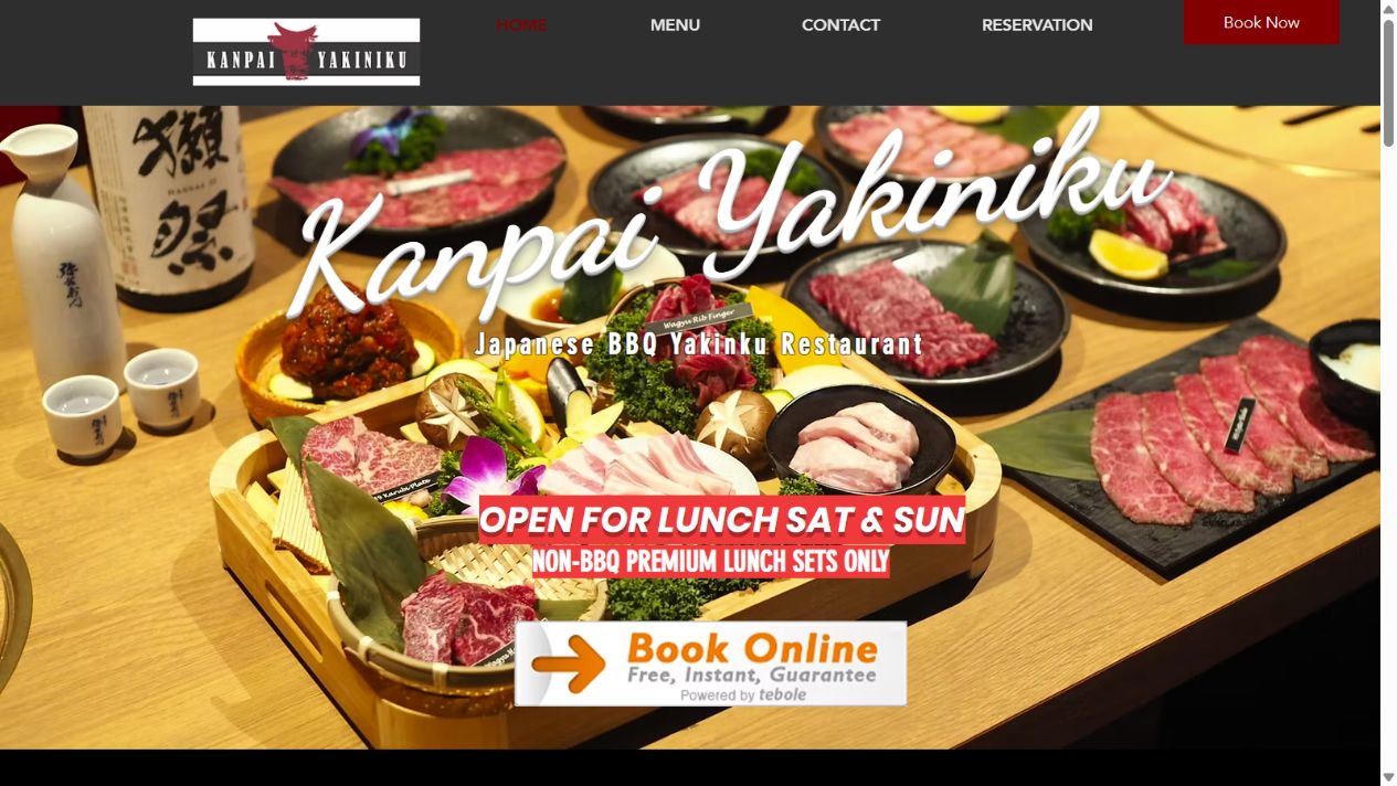 Kanpai Yakiniku’s actual homepage, featuring its white wordmark over a spread of Japanese barbecue dishes.